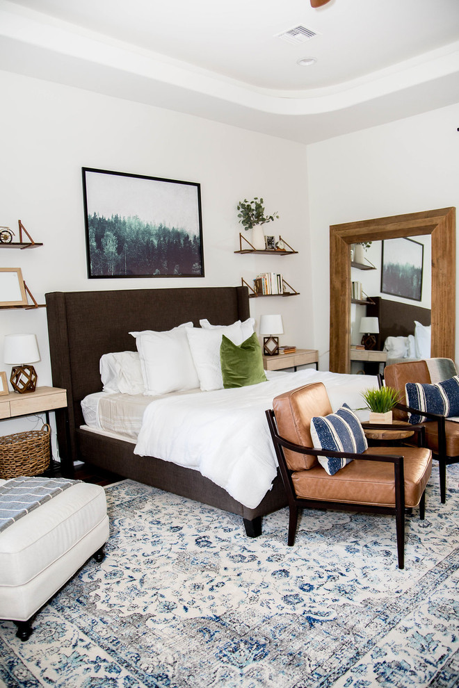 Example of a mid-sized eclectic master laminate floor and brown floor bedroom design in Phoenix with white walls