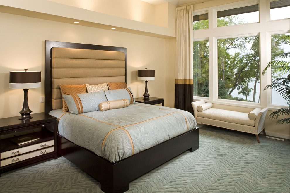Design ideas for a contemporary master bedroom in Minneapolis with beige walls and carpet.