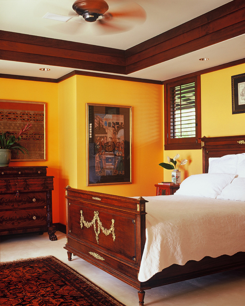 This is an example of a world-inspired bedroom in Hawaii with yellow walls.
