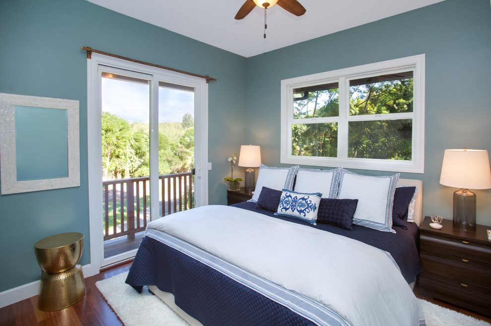 Small nautical master bedroom in Hawaii with blue walls.