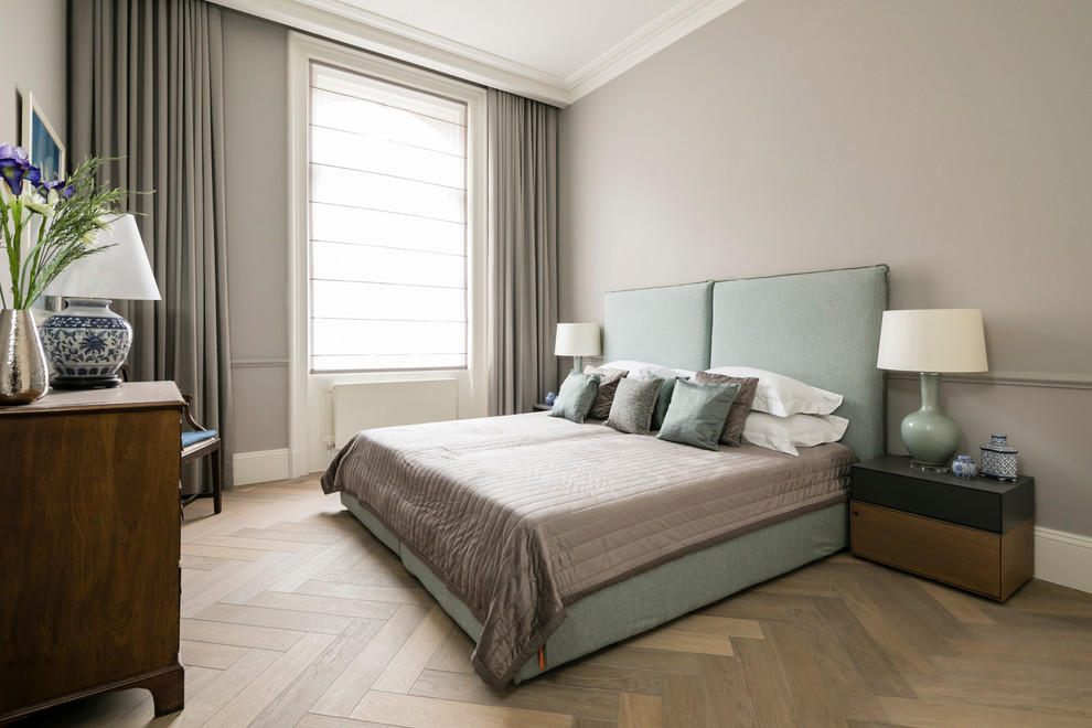 Design ideas for a large contemporary master bedroom in London with grey walls, light hardwood flooring, no fireplace and brown floors.