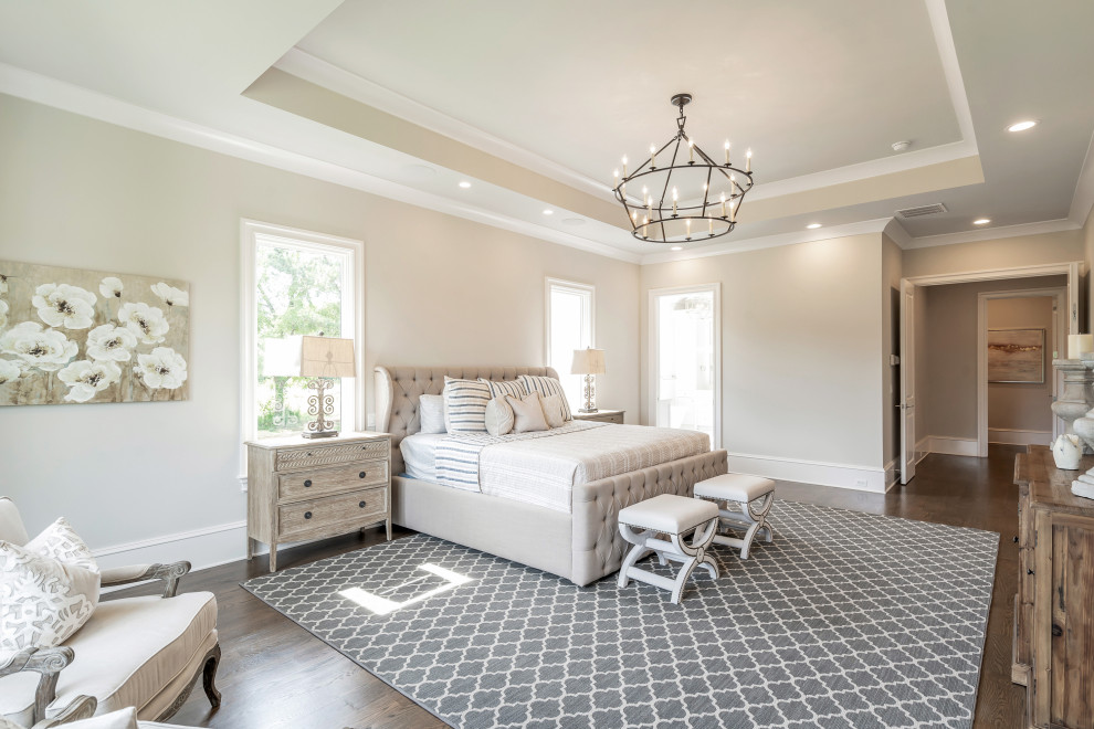 Large farmhouse master dark wood floor and brown floor bedroom photo in Atlanta with gray walls