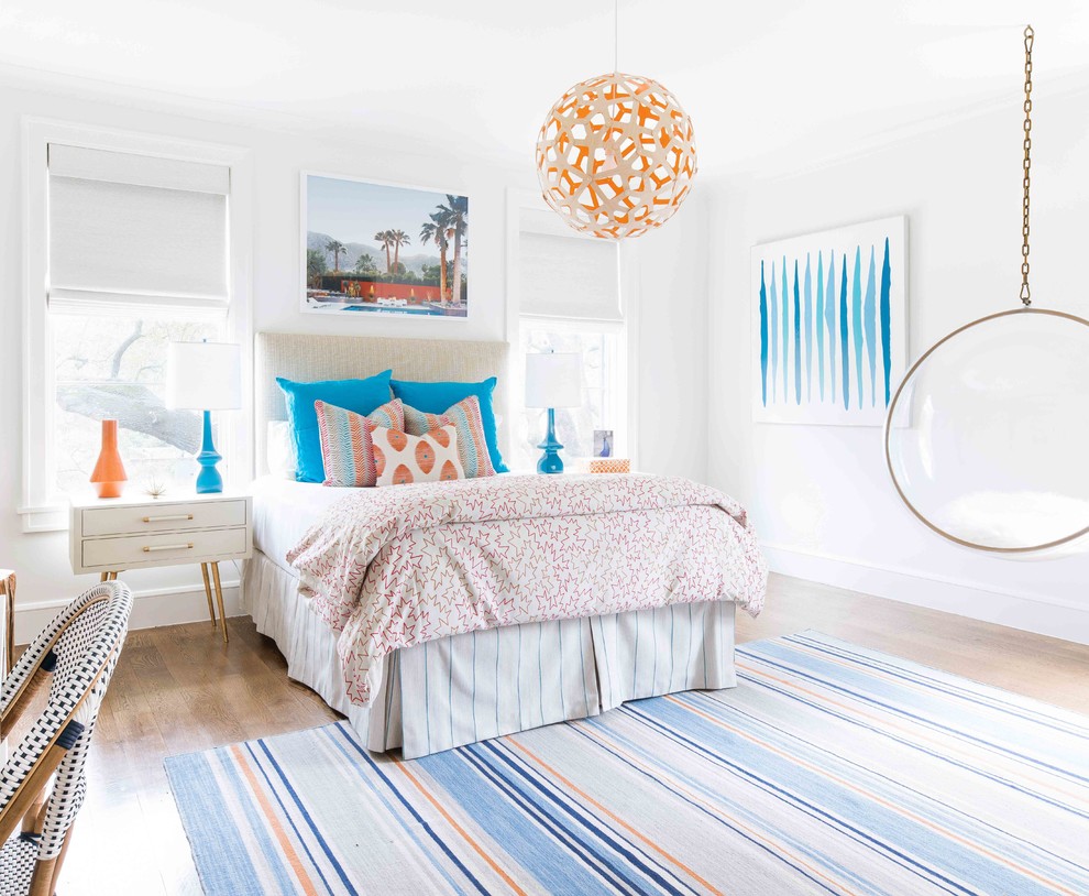 Photo of a nautical bedroom in Dallas with white walls, medium hardwood flooring and no fireplace.