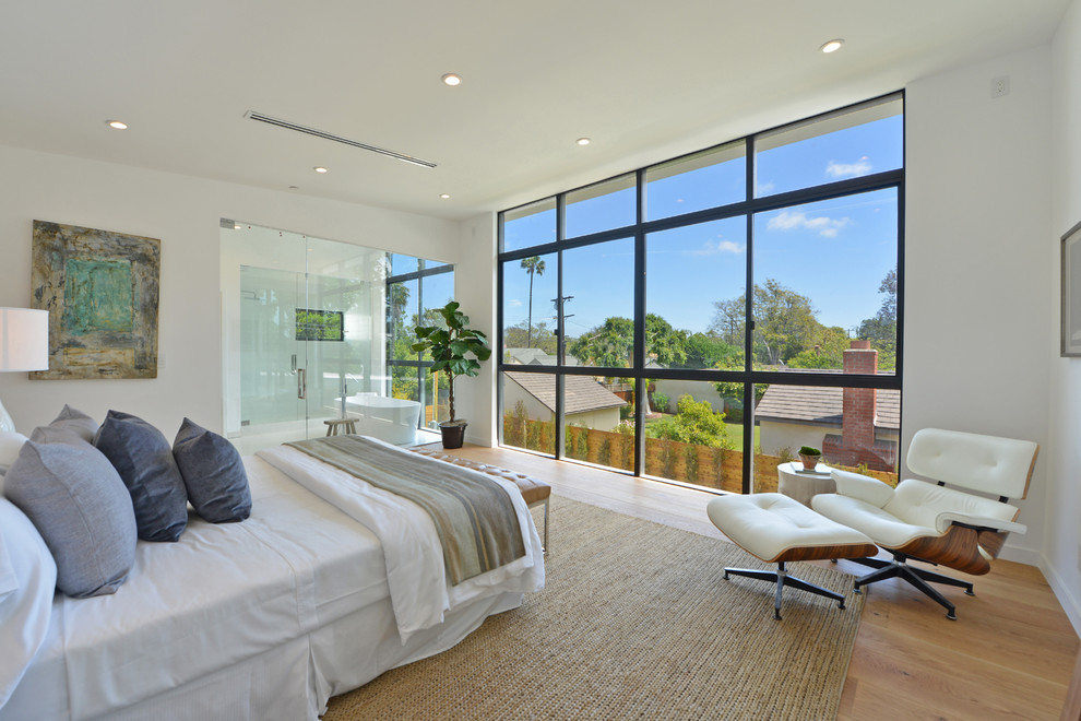 Inspiration for a large contemporary master light wood floor and brown floor bedroom remodel in Los Angeles with white walls and no fireplace
