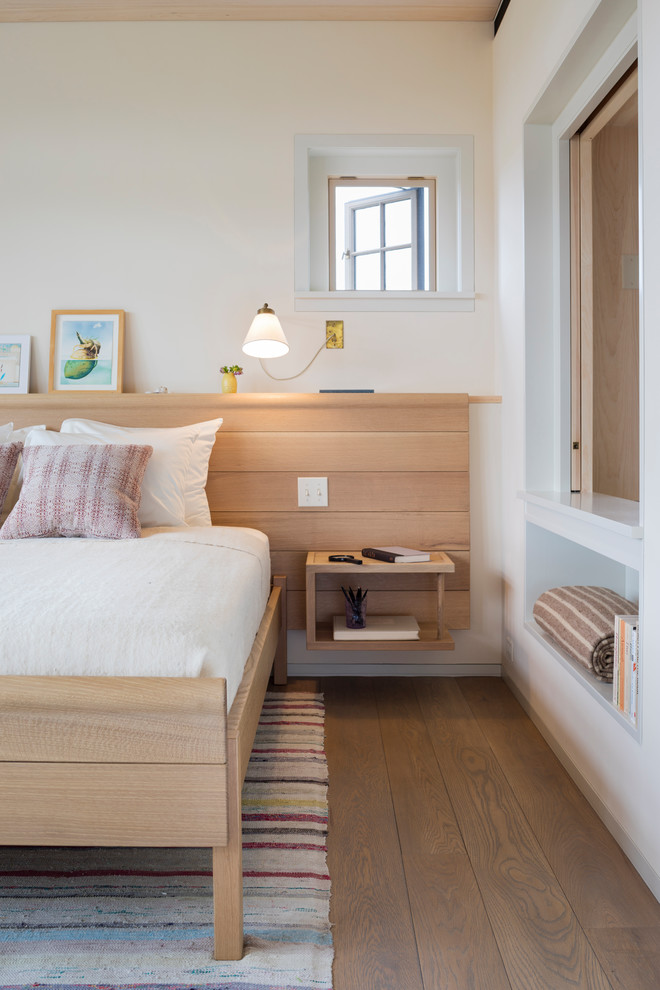 Mid-sized beach style guest medium tone wood floor and brown floor bedroom photo in Boston with white walls