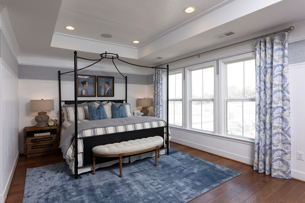 This is an example of a large nautical master bedroom in DC Metro with multi-coloured walls, vinyl flooring, no fireplace and brown floors.