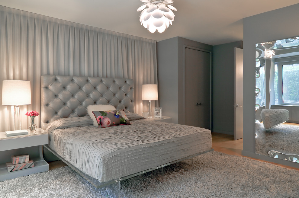 Design ideas for a large contemporary master and grey and silver bedroom in New York with grey walls and no fireplace.