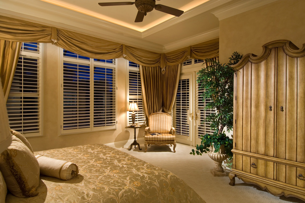 Inspiration for a large classic master bedroom in Miami with beige walls, carpet, no fireplace and beige floors.
