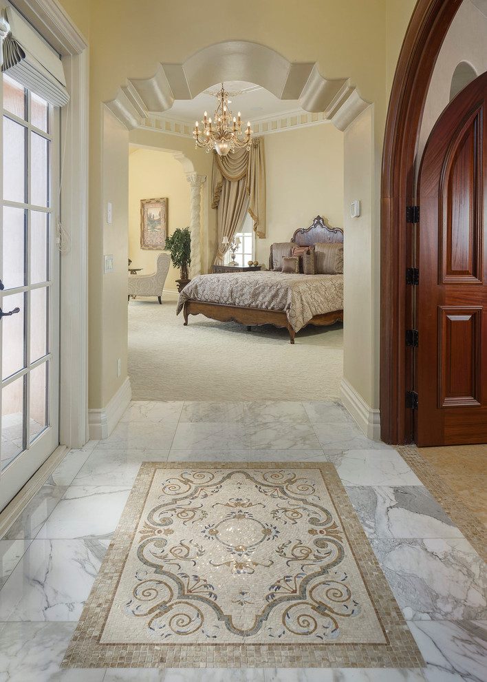 Large tuscan master carpeted and beige floor bedroom photo in Orlando with beige walls and no fireplace
