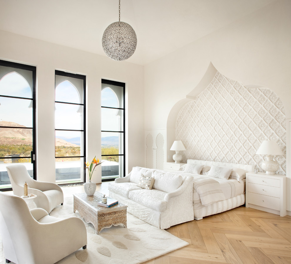 Inspiration for a transitional light wood floor bedroom remodel in Other with white walls