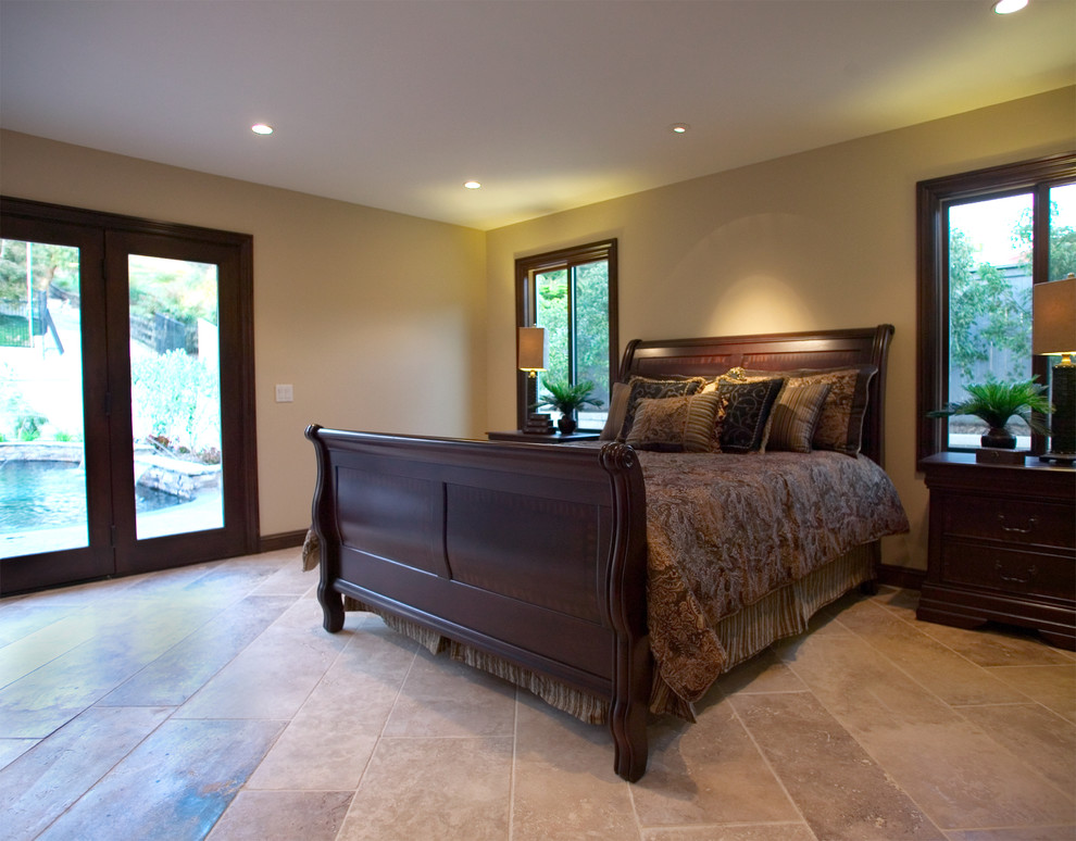 Bedroom - huge traditional master travertine floor and beige floor bedroom idea in Los Angeles with beige walls