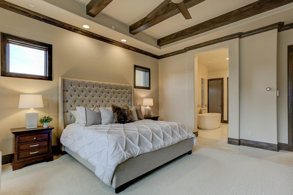 Example of a huge tuscan master carpeted and beige floor bedroom design in Denver with beige walls and no fireplace