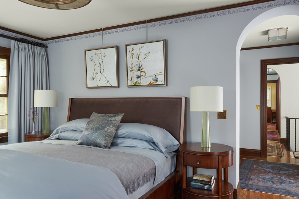 Mediterranean bedroom in Minneapolis with grey walls, medium hardwood flooring and brown floors.
