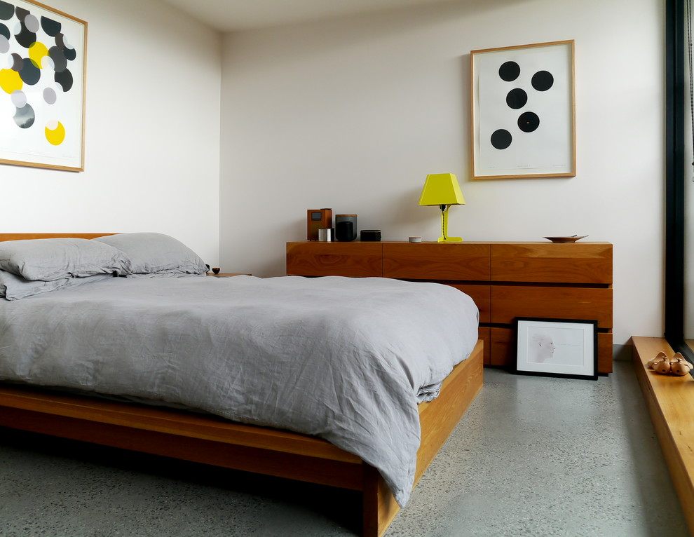 Scandi guest bedroom in Melbourne with concrete flooring.