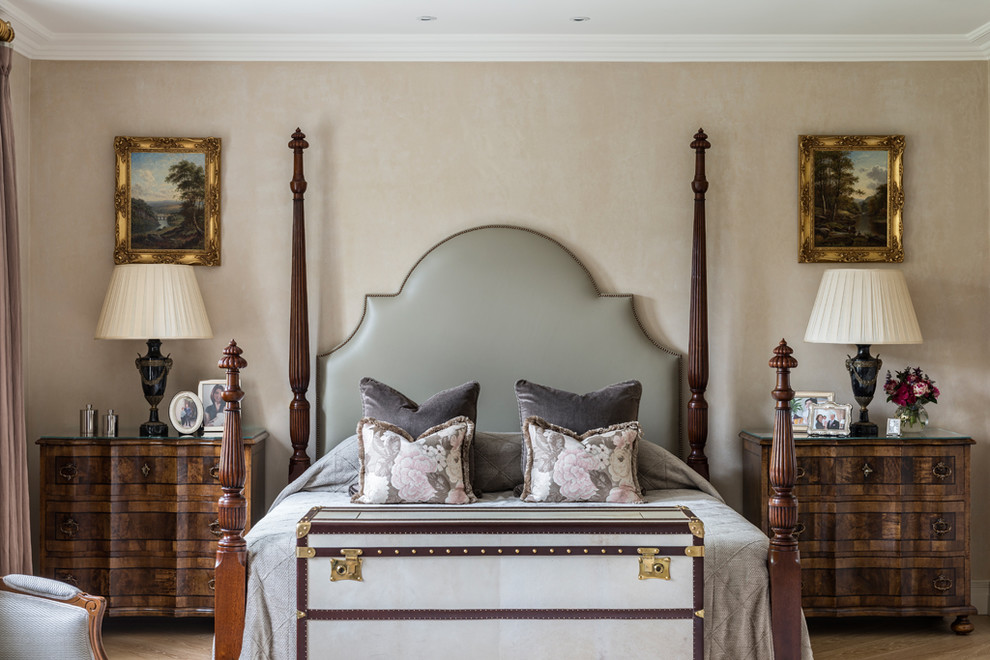 This is an example of a victorian master bedroom in London with beige walls.