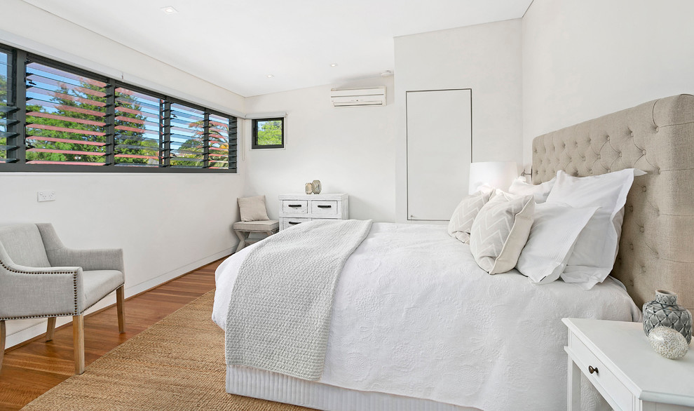 Design ideas for a medium sized classic master bedroom in Sydney with white walls and medium hardwood flooring.