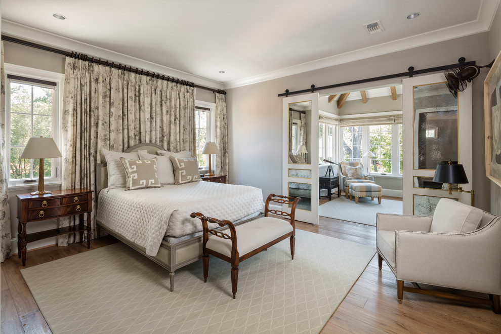 Inspiration for a traditional grey and cream bedroom in Houston with grey walls and medium hardwood flooring.