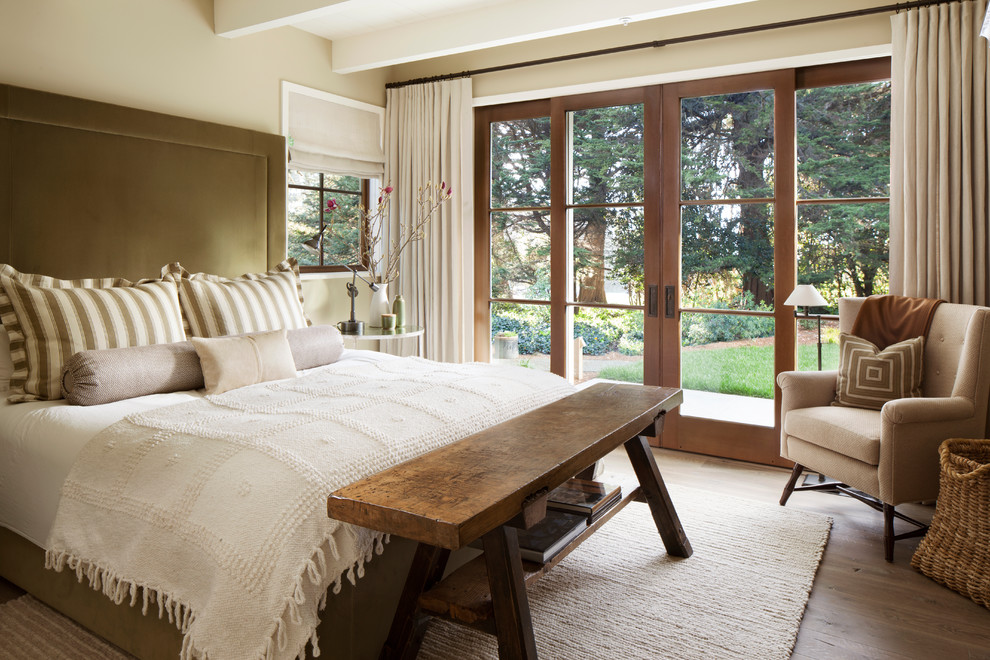 Example of a country master light wood floor bedroom design in San Francisco with beige walls