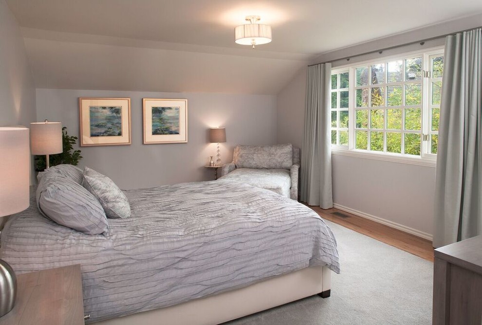 This is an example of a medium sized traditional guest bedroom in Seattle with grey walls, light hardwood flooring and no fireplace.