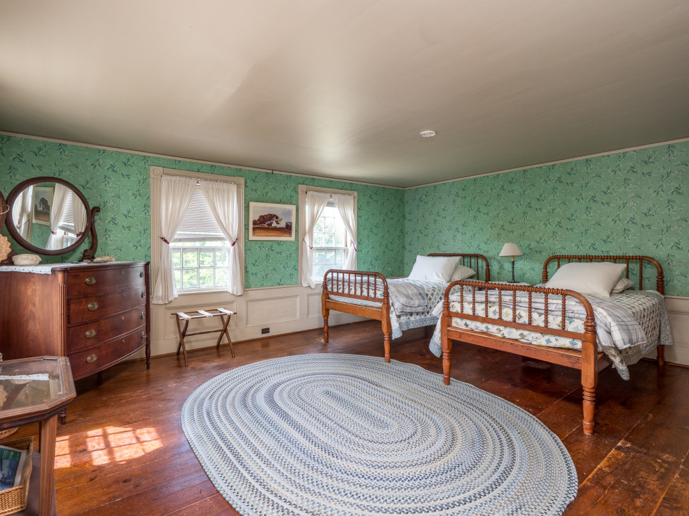 Modelo de habitación de invitados de estilo de casa de campo grande con paredes verdes y suelo de madera en tonos medios