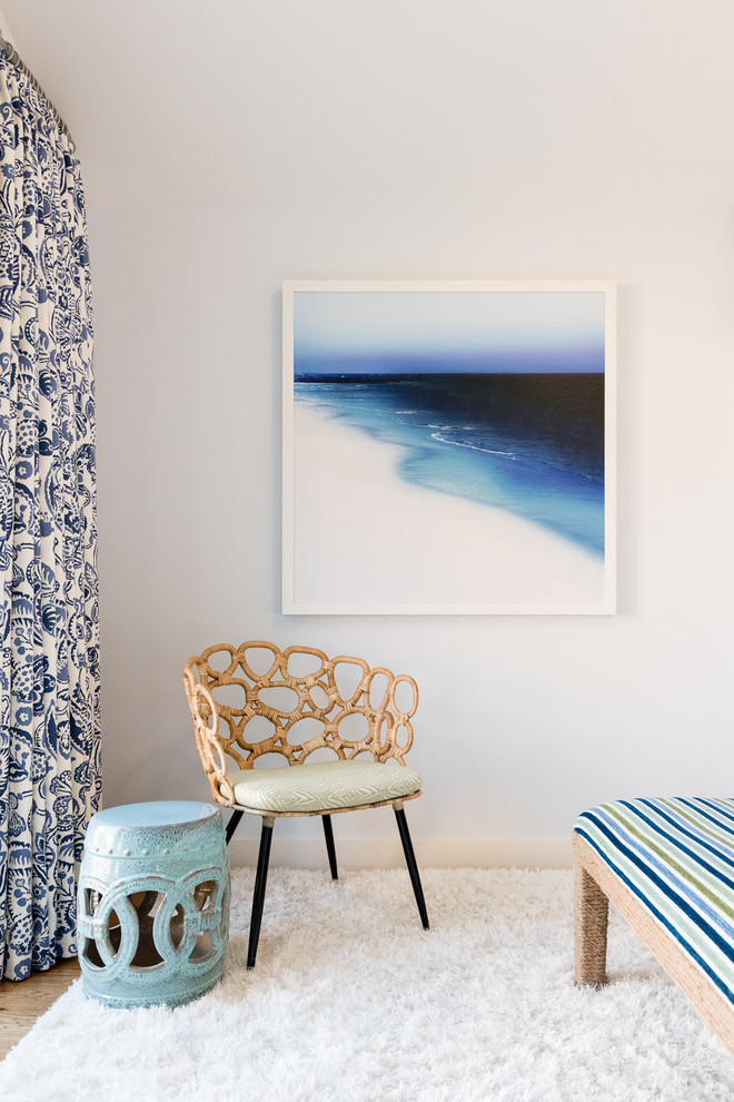 Example of a beach style light wood floor bedroom design in Santa Barbara with white walls