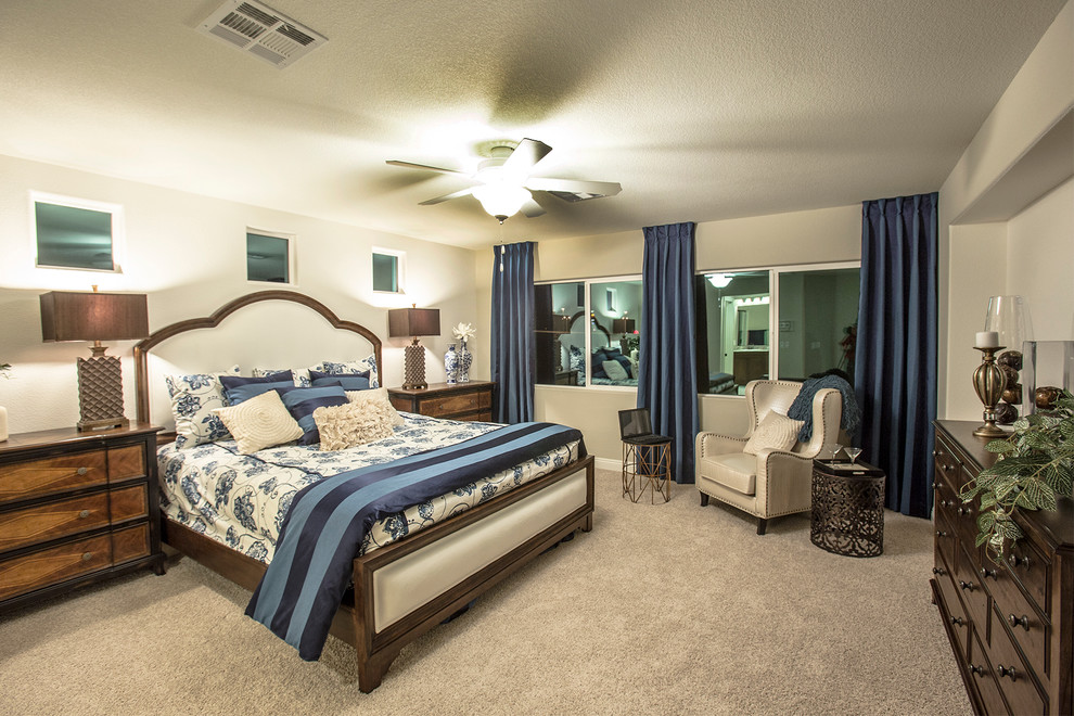 This is an example of a medium sized contemporary master bedroom in Las Vegas with beige walls and carpet.