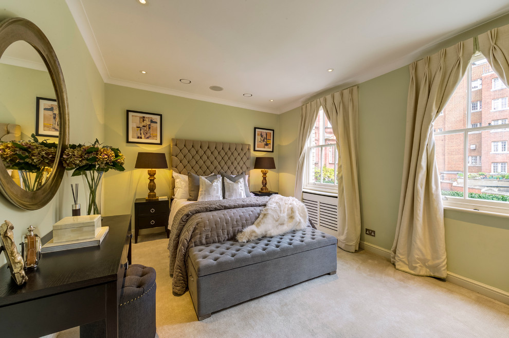 Design ideas for a classic grey and brown bedroom in London with green walls and carpet.