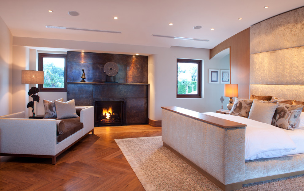 Inspiration for a contemporary bedroom remodel in Miami with a metal fireplace and a standard fireplace