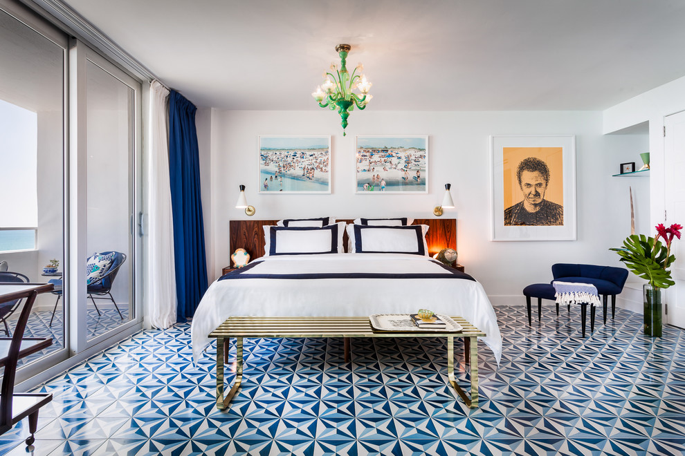 This is an example of a coastal bedroom in Miami with white walls and blue floors.