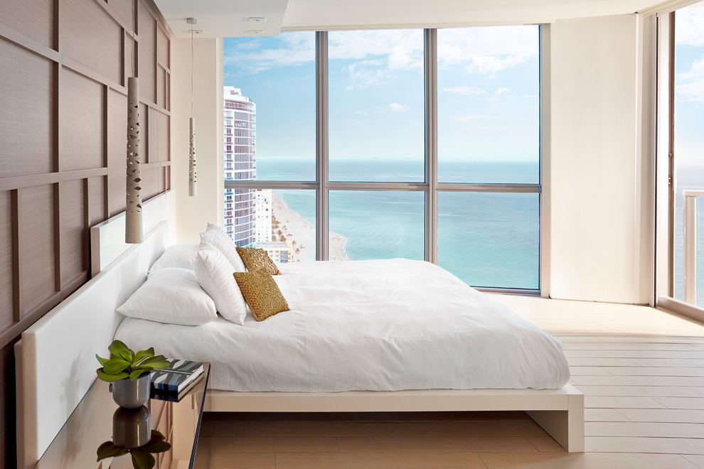 Medium sized coastal master bedroom in Miami.