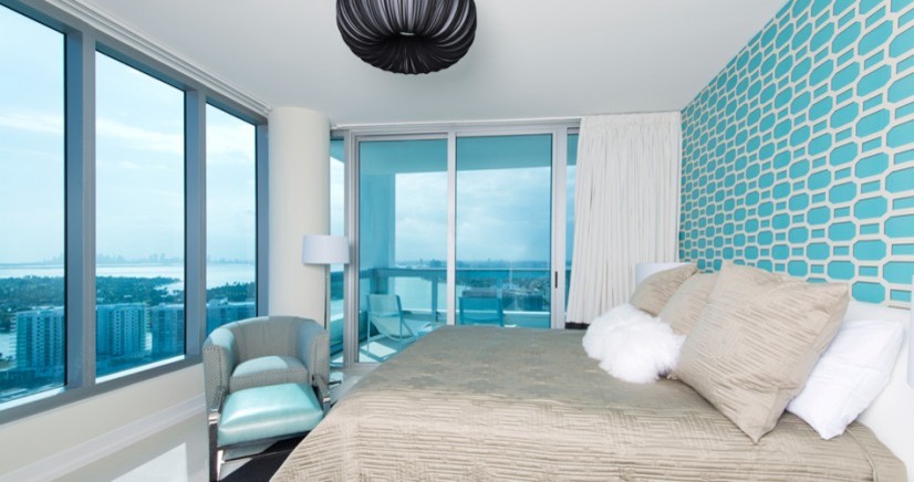 Inspiration for a beach style master bedroom in Miami with blue walls and ceramic flooring.