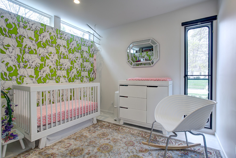 Example of a 1960s light wood floor nursery design in Grand Rapids with white walls