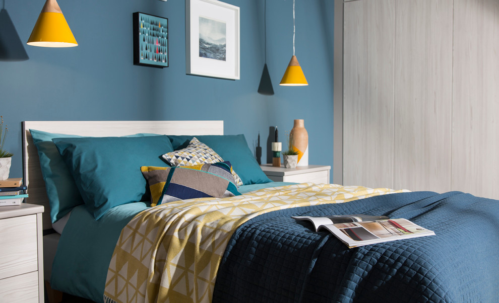 Example of a mid-sized 1960s guest bedroom design in West Midlands with blue walls