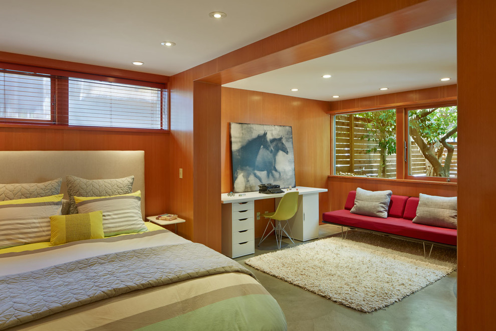 Example of a small 1960s master concrete floor bedroom design in San Francisco with brown walls