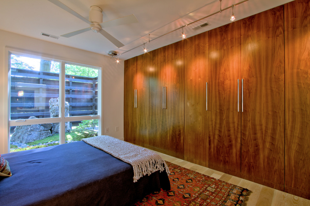 Diseño de dormitorio principal vintage de tamaño medio sin chimenea con paredes blancas, suelo de madera clara y suelo beige