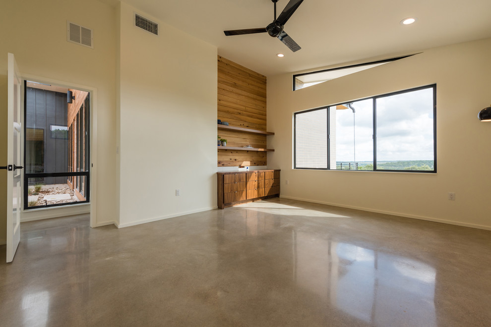 Design ideas for a large retro master bedroom in Austin with white walls, concrete flooring and no fireplace.