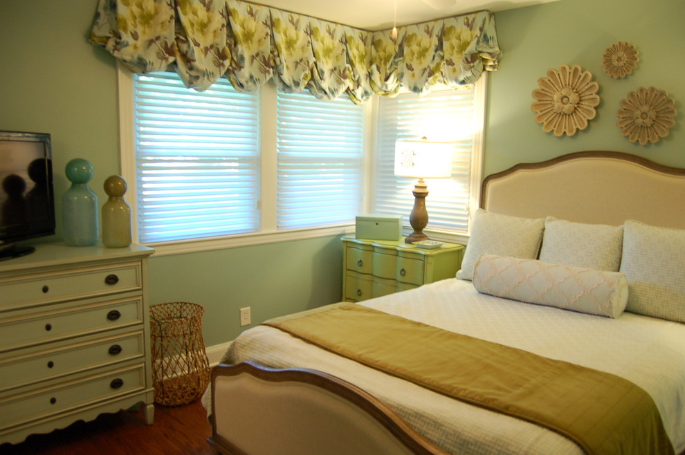Medium sized retro master bedroom in Louisville with blue walls and medium hardwood flooring.