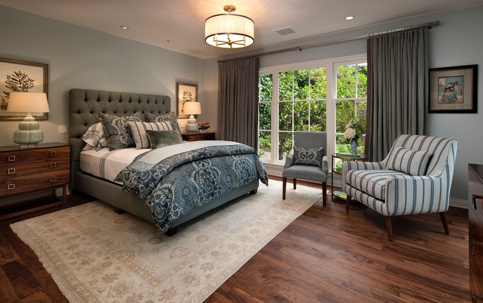 Large traditional master and grey and brown bedroom in Los Angeles with green walls, medium hardwood flooring, no fireplace and brown floors.
