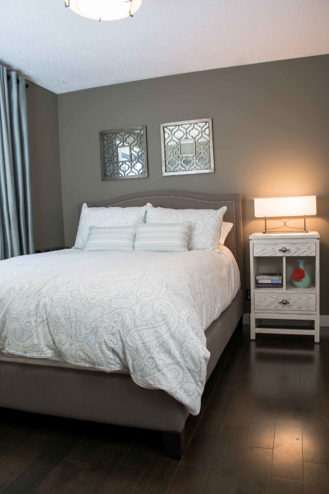 Inspiration for a small traditional master and grey and brown bedroom in Calgary with dark hardwood flooring, no fireplace, grey walls and brown floors.