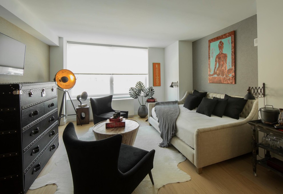 Mid-sized eclectic guest light wood floor and beige floor bedroom photo in New York with beige walls and no fireplace