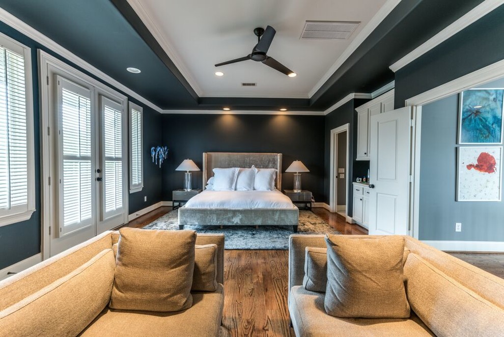 Inspiration for a large transitional master medium tone wood floor and brown floor bedroom remodel in Houston with black walls and no fireplace