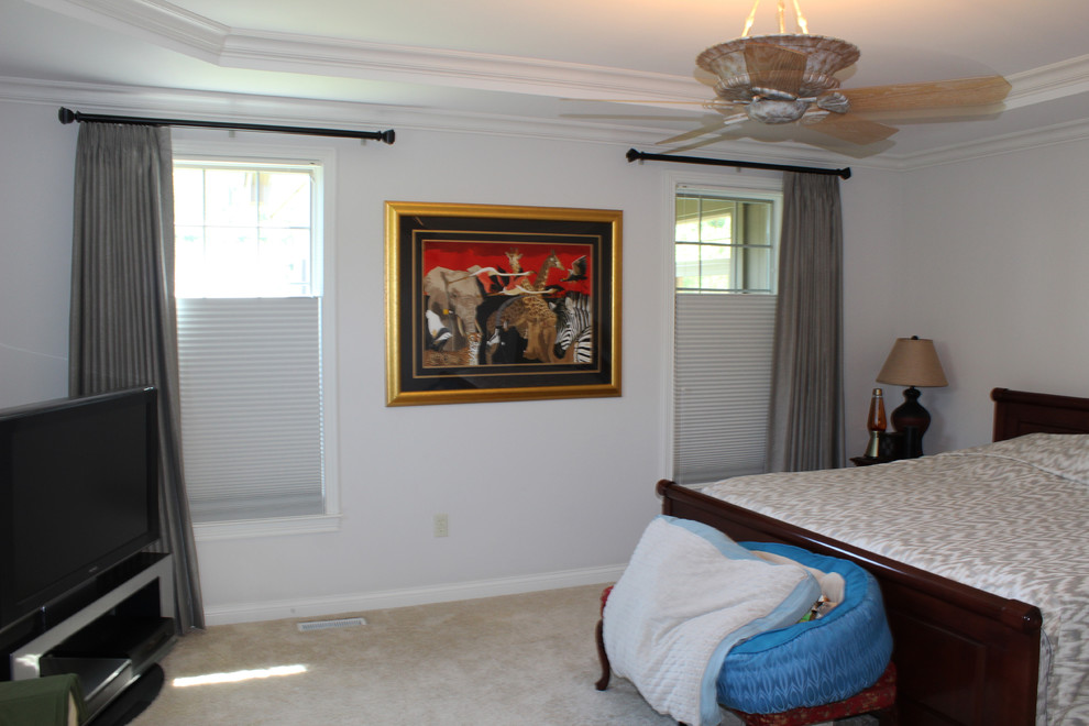 This is an example of a large classic master bedroom in Cincinnati with white walls, carpet and no fireplace.