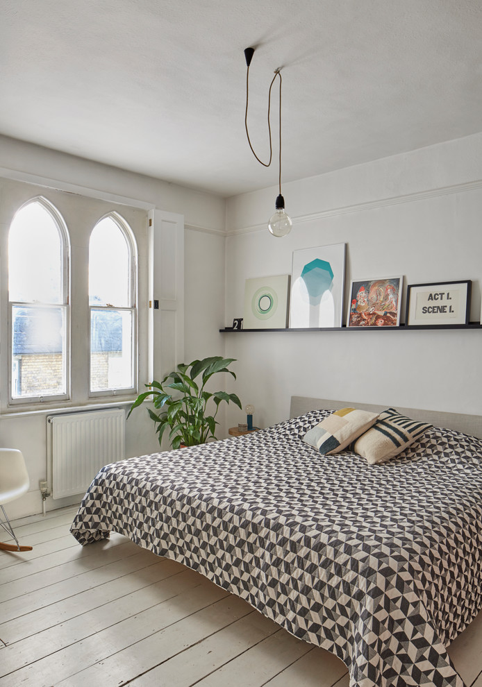 Bedroom - mid-sized scandinavian painted wood floor and beige floor bedroom idea in Essex with white walls