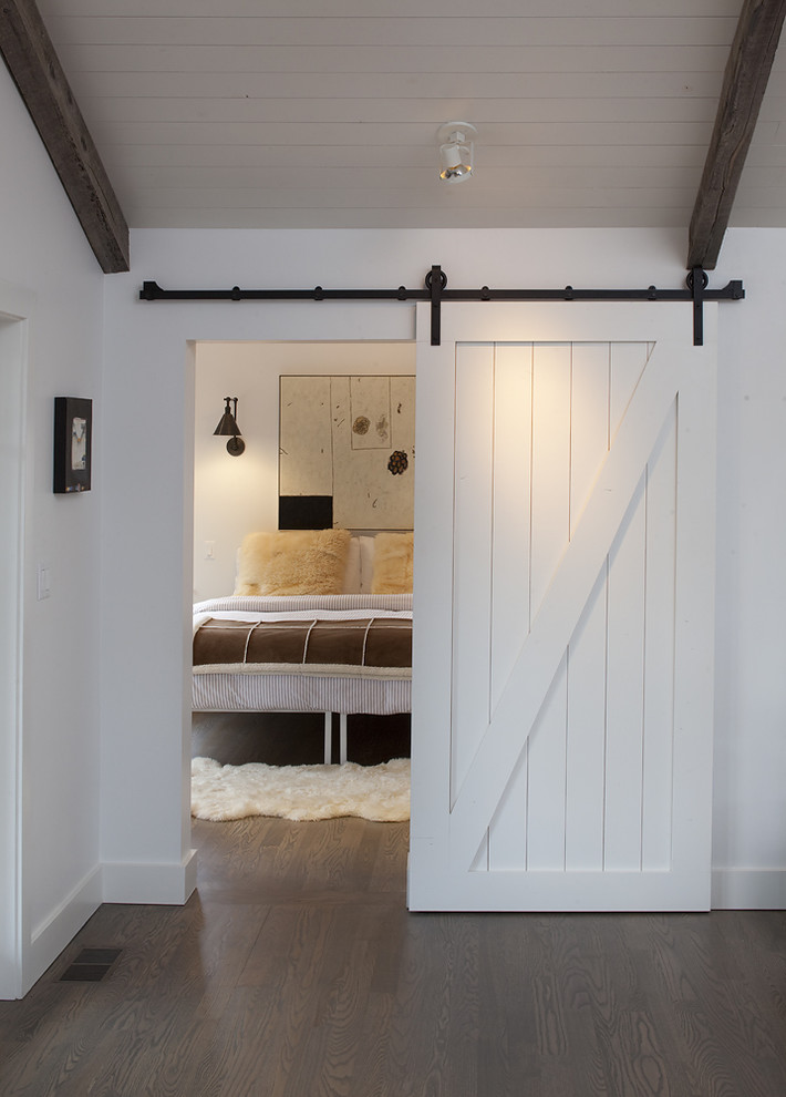 Inspiration for a country dark wood floor bedroom remodel in San Francisco with white walls