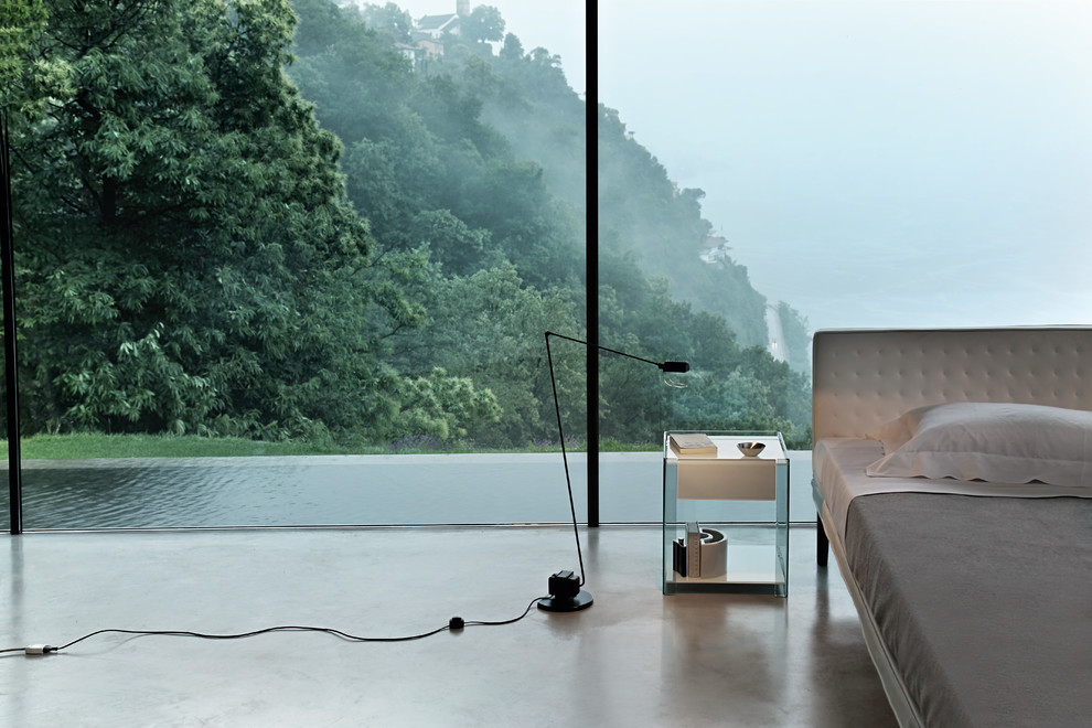 Ispirazione per una camera matrimoniale minimal di medie dimensioni con pavimento in cemento e pavimento grigio