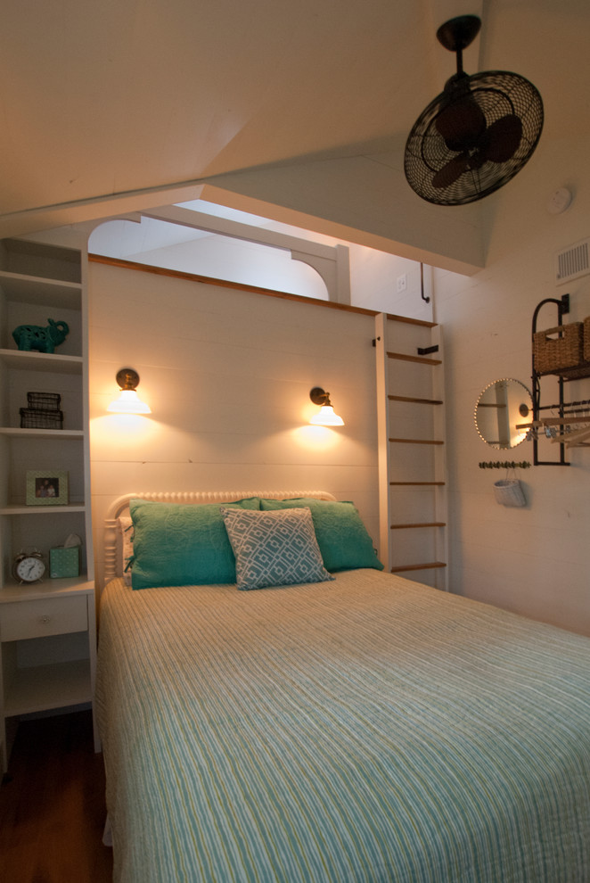 Inspiration for a nautical bedroom in Other with white walls and medium hardwood flooring.