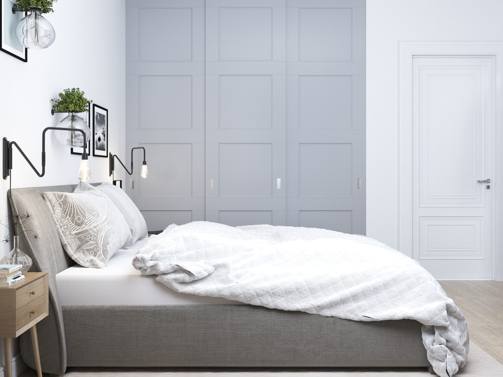 Cette image montre une petite chambre parentale nordique avec un mur blanc et parquet clair.