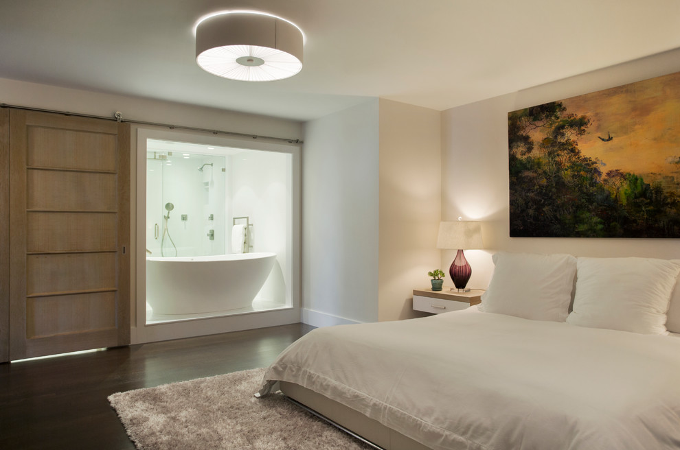 Inspiration for a contemporary master bedroom in Boston with beige walls and dark hardwood flooring.