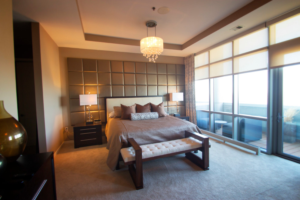 This is an example of a large contemporary master bedroom in Minneapolis with beige walls and carpet.