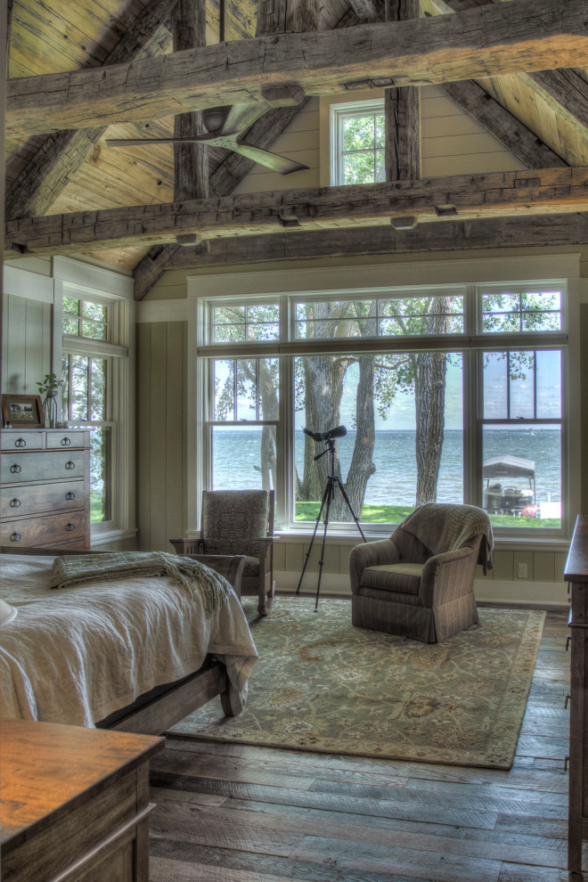 Ejemplo de dormitorio principal rural de tamaño medio con paredes multicolor, suelo de madera en tonos medios y suelo marrón